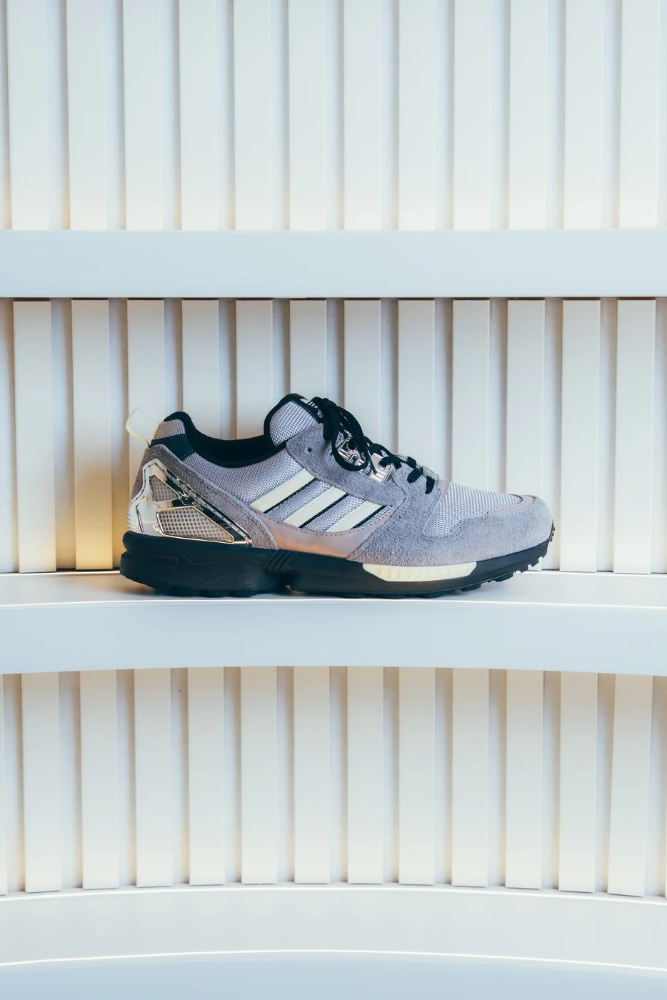 adidas ZX8000 product still life on a curved illuminated shelf